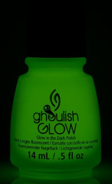 bottle of china glaze ghoulish glow in the dark nail polish glowing with the lights off