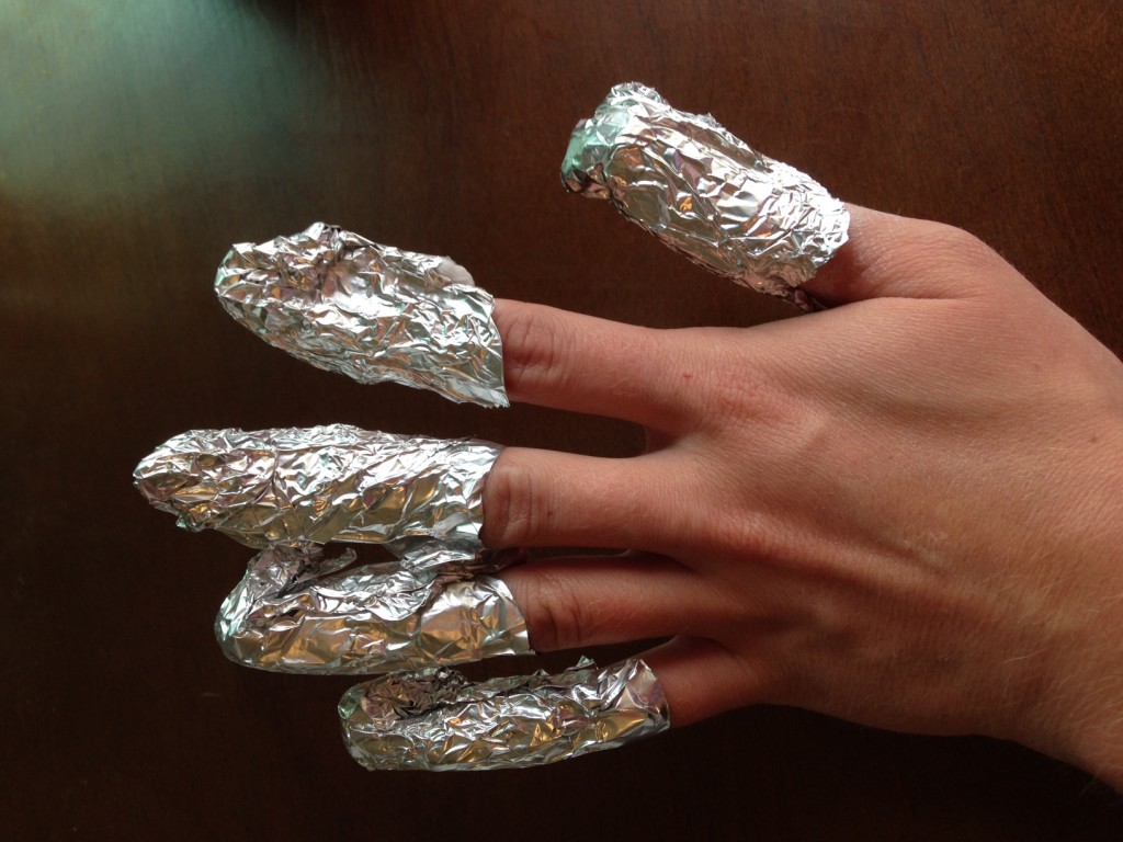 Hand with finger tips wrapped in aluminum foil