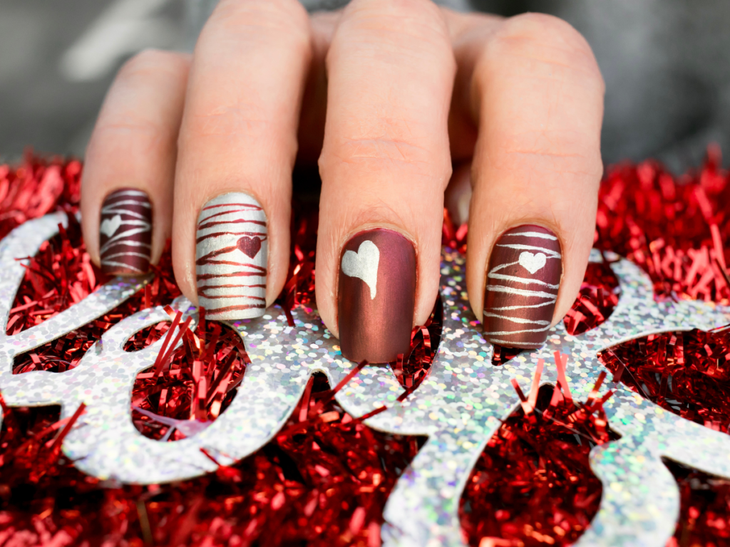 Metallic dark red brown valentine's nails with silver hearts
